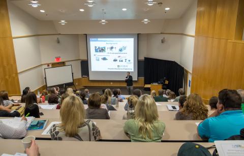 photo of a lecture hall full of seated people